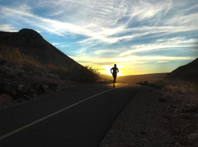 Runner on road at sunrise